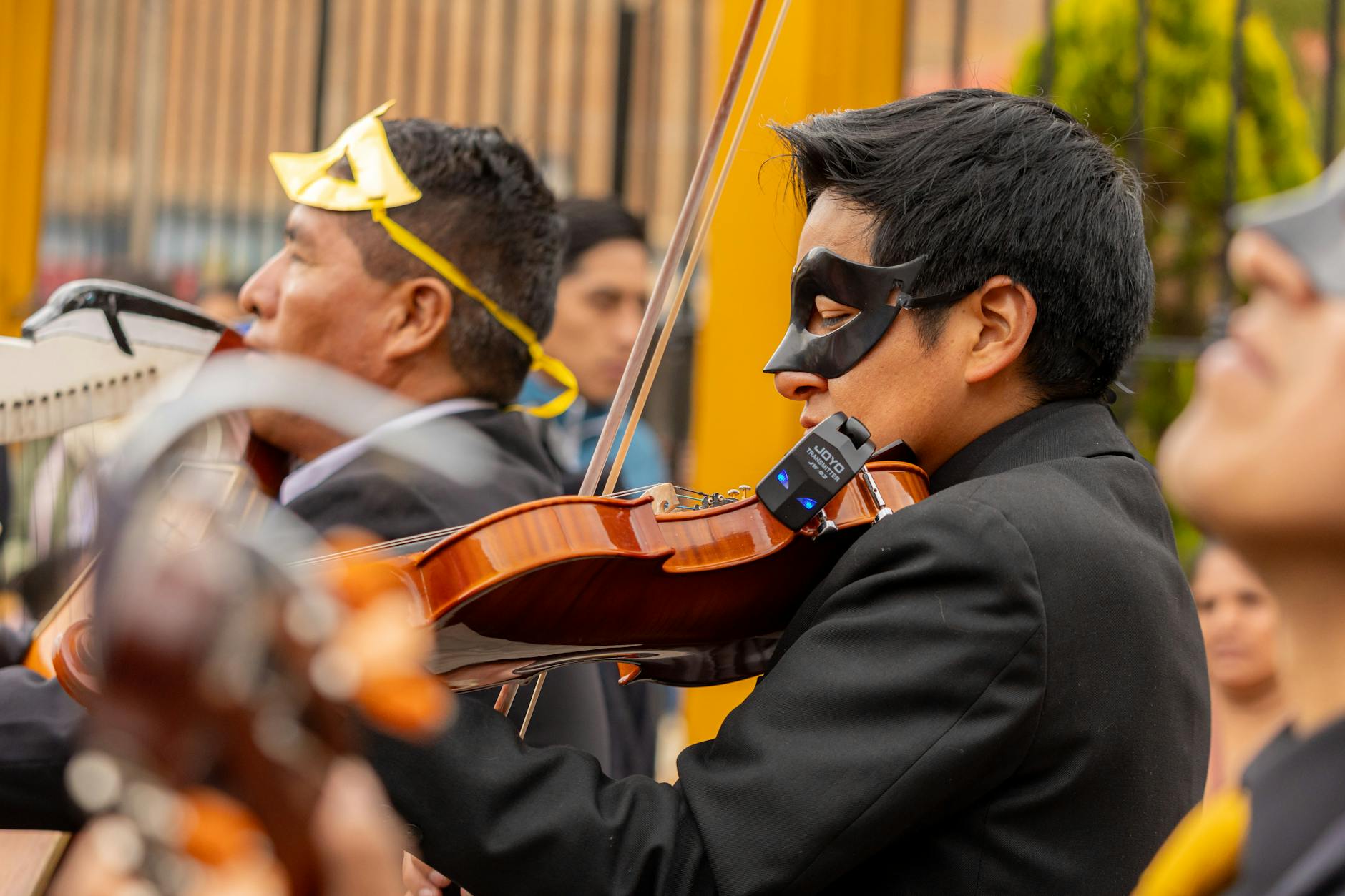 Symphony orchestra performing at outdoor music festival with audience watching