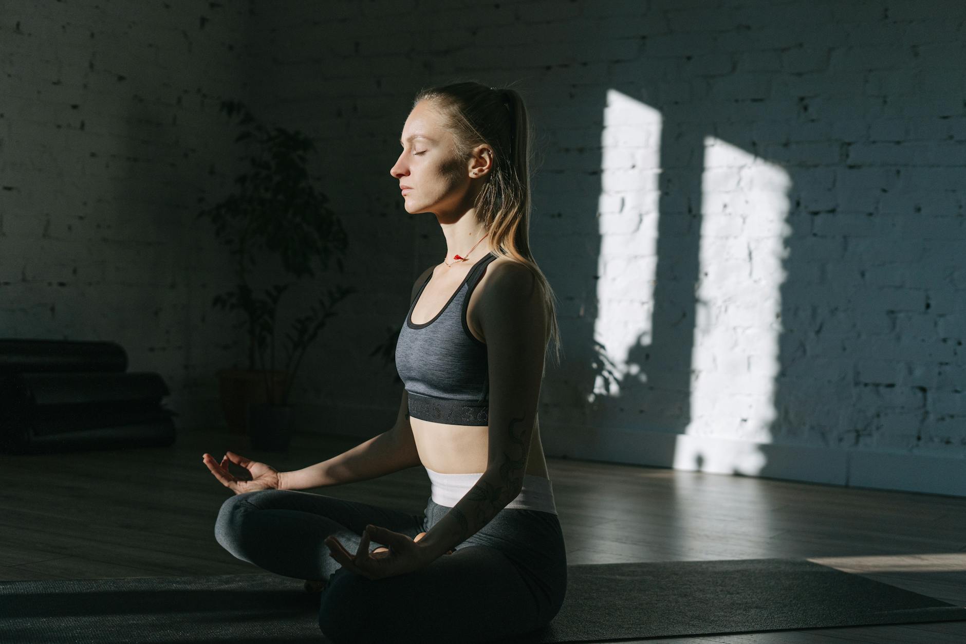 Woman sitting peacefully in meditation pose practicing mindfulness exercises