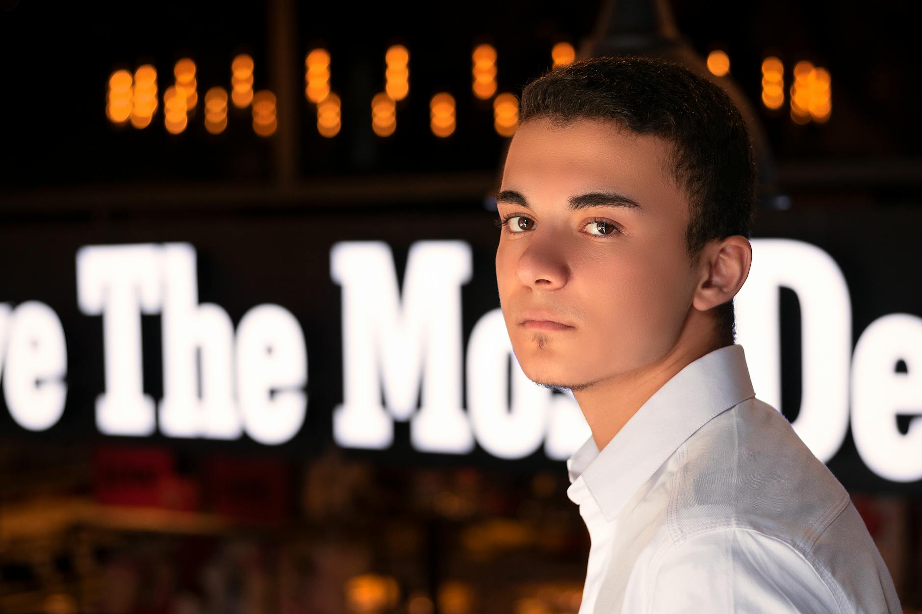 Young man wearing casual outfit with jewelry, representing modern gender-neutral fashion trends