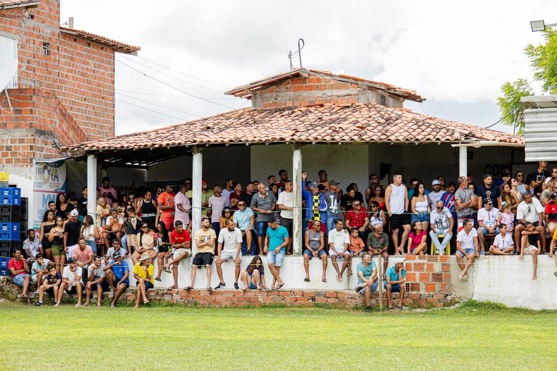 Audience seated in theater watching a large screen with focused attention