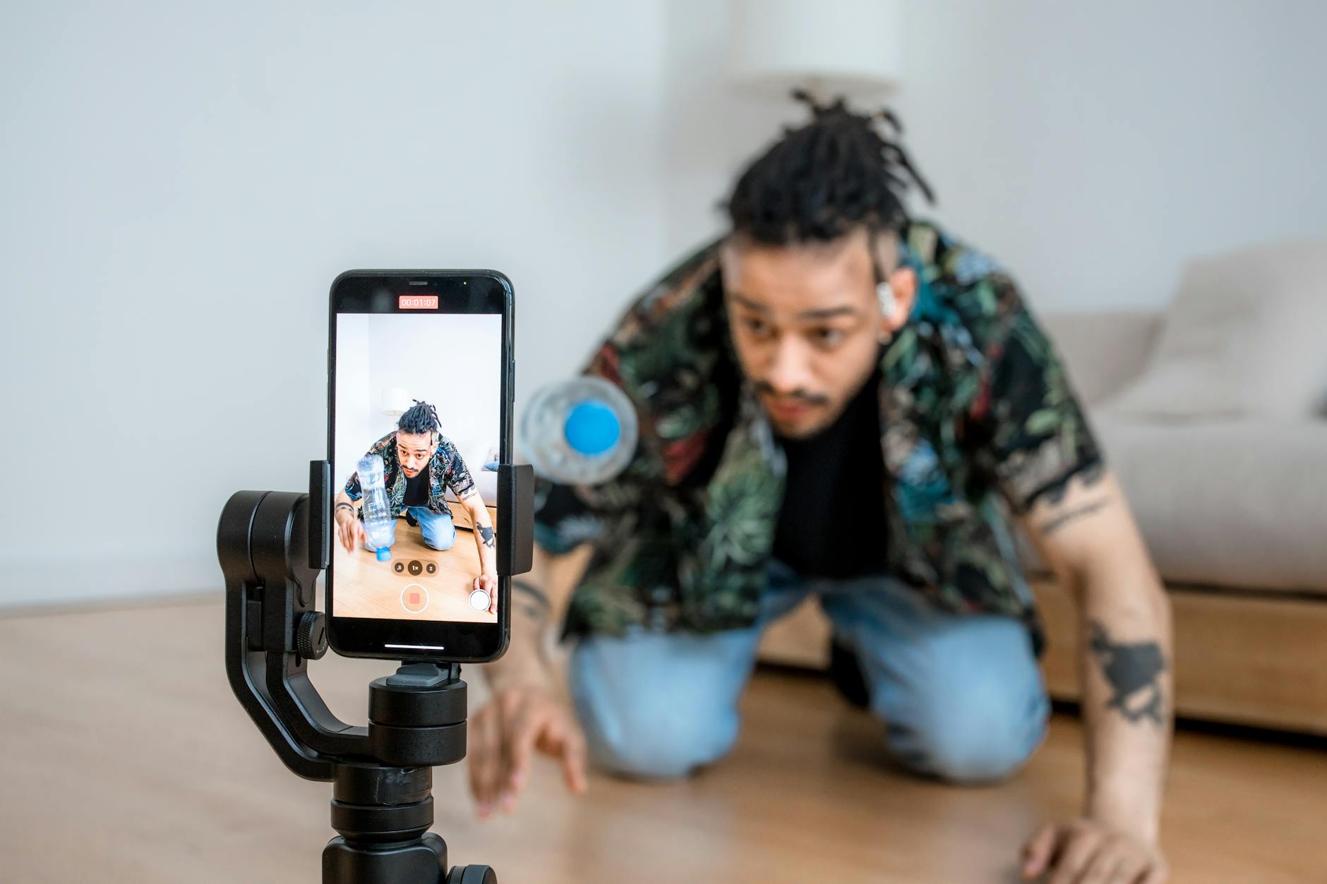 Content creator using smartphone to record video in professional setup