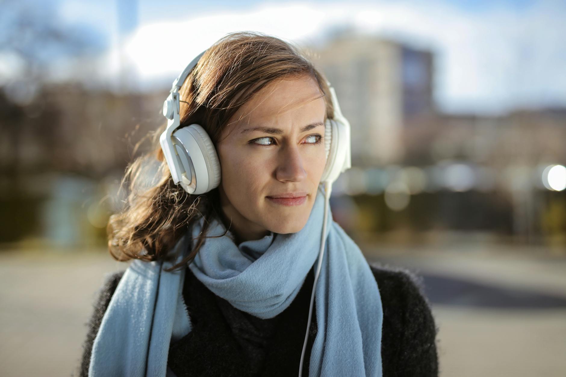 Young woman wearing headphones during digital meditation session