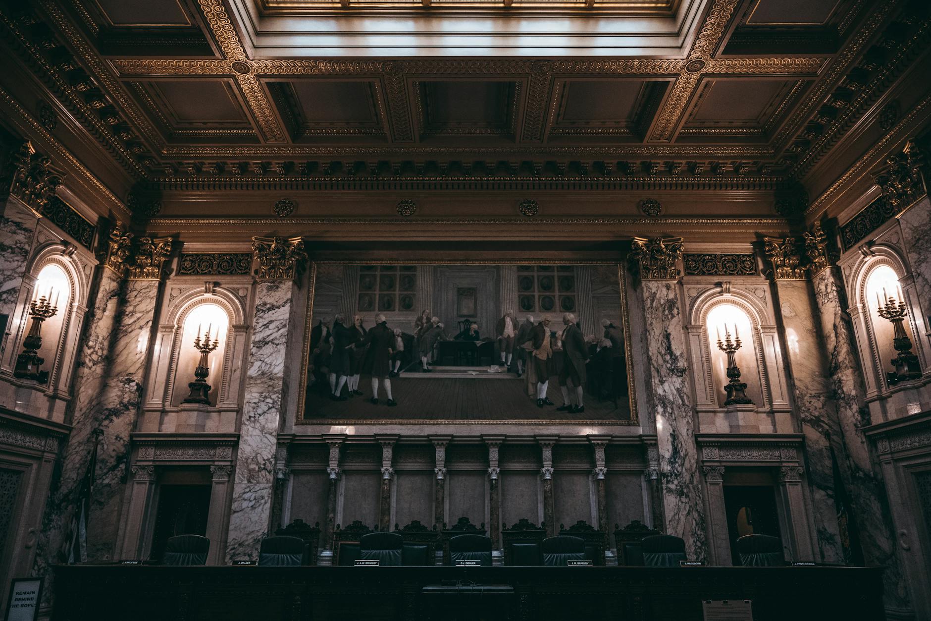 Traditional courtroom with wooden benches, judge's bench, and American flag