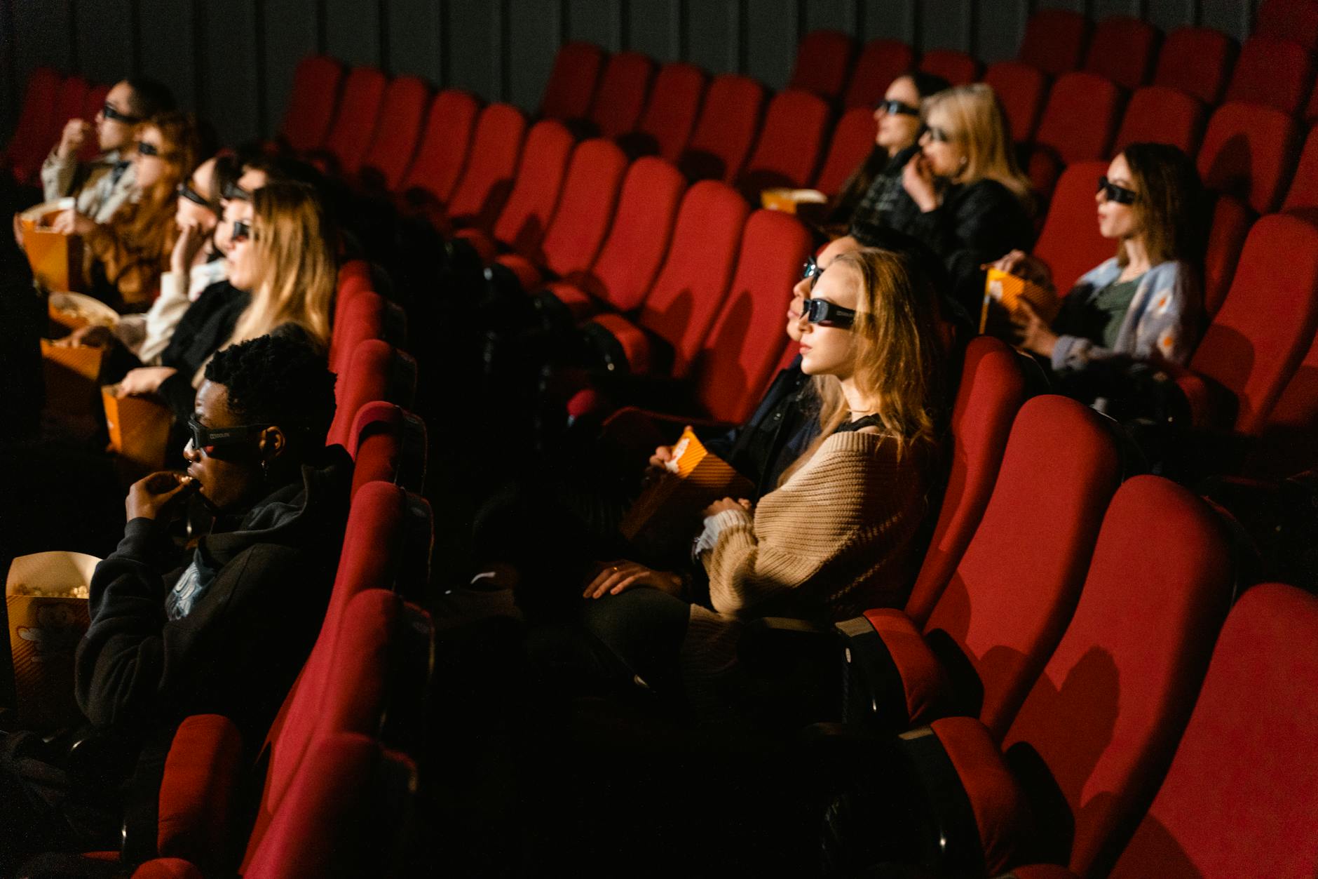 Theater audience clapping and smiling during a live performance
