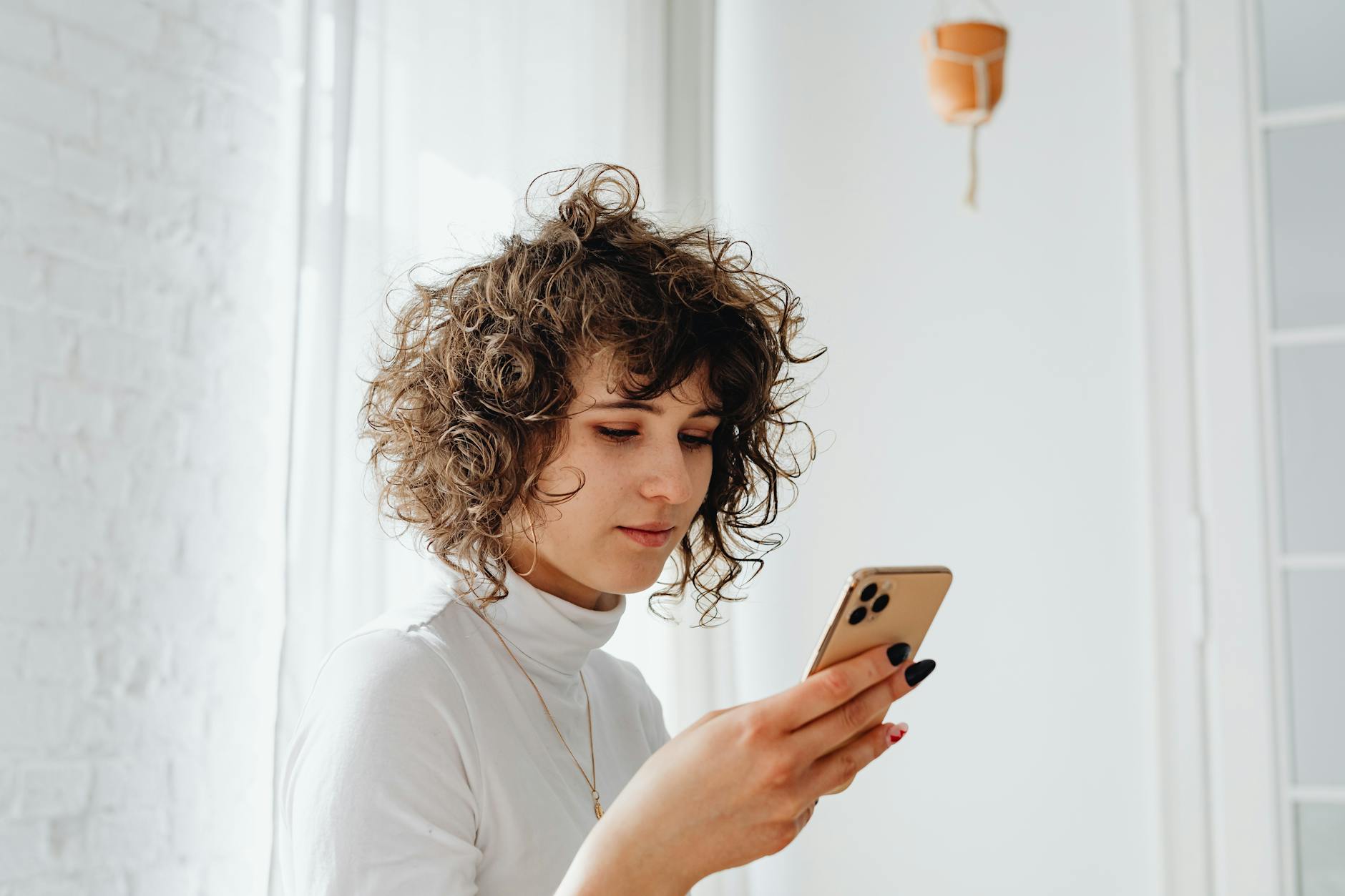 Young woman reading on smartphone, representing social media's influence on book discovery