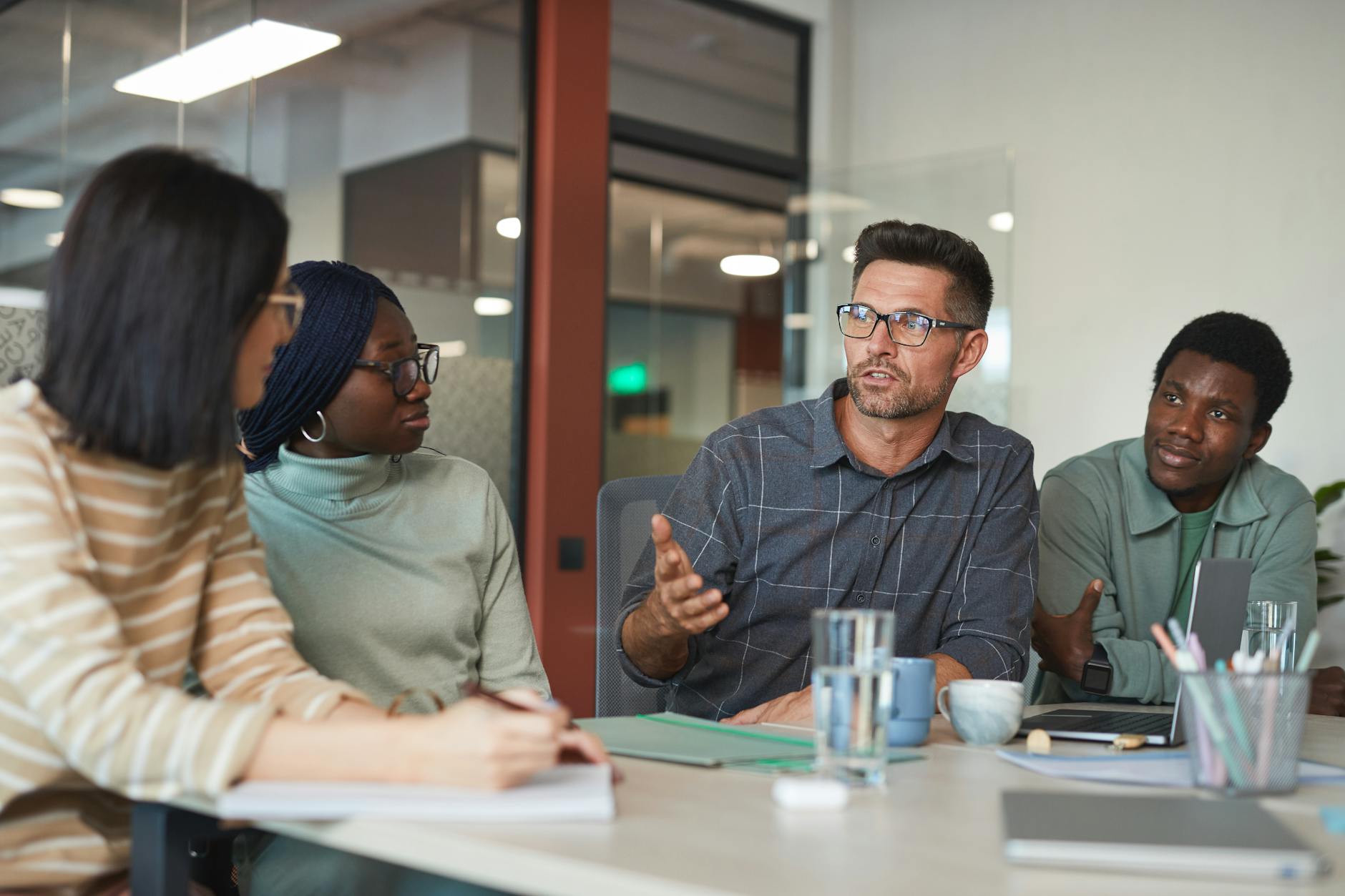 Group of people engaged in animated discussion around a table