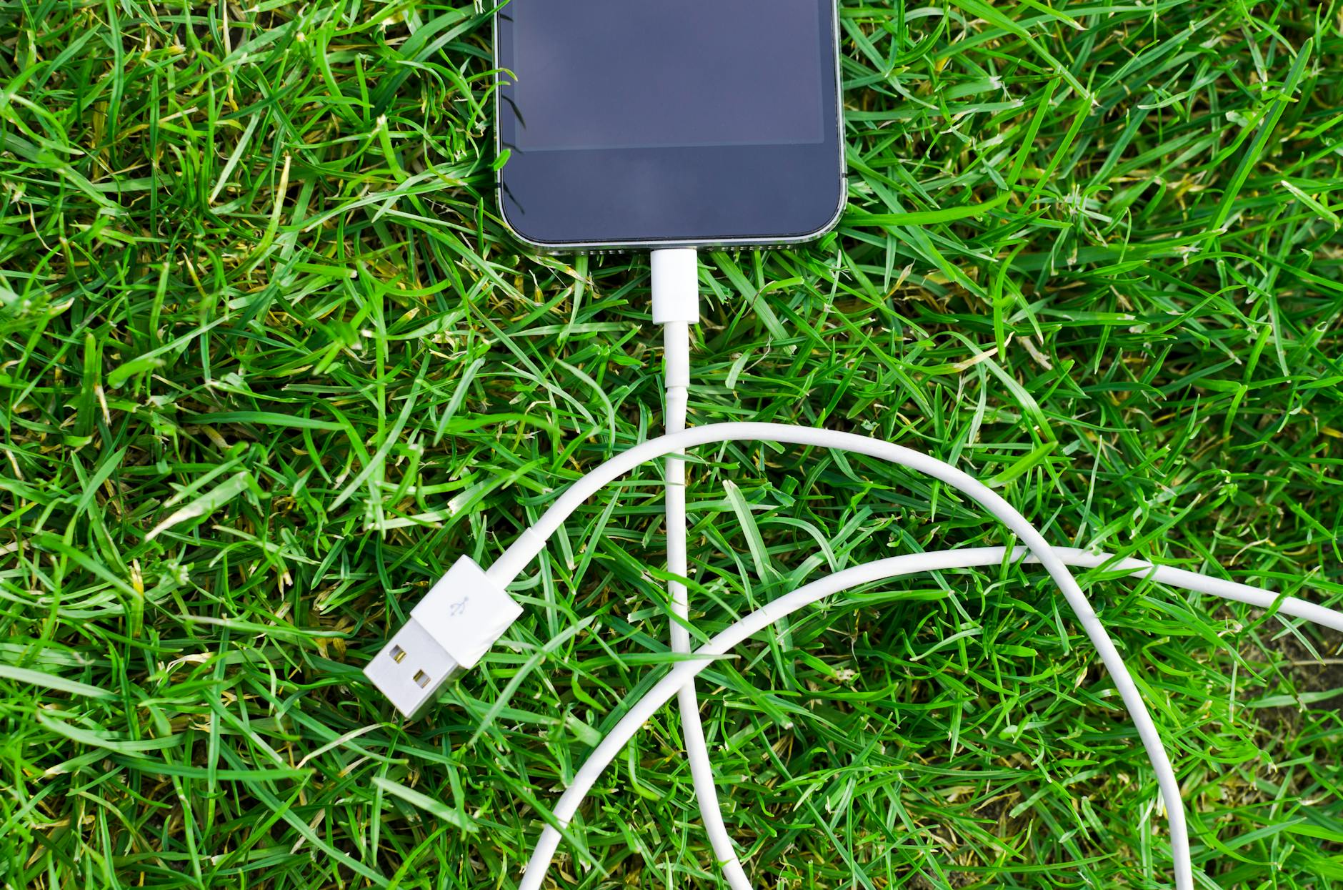 Smartphone placed on charging surface showing wireless power technology in everyday use