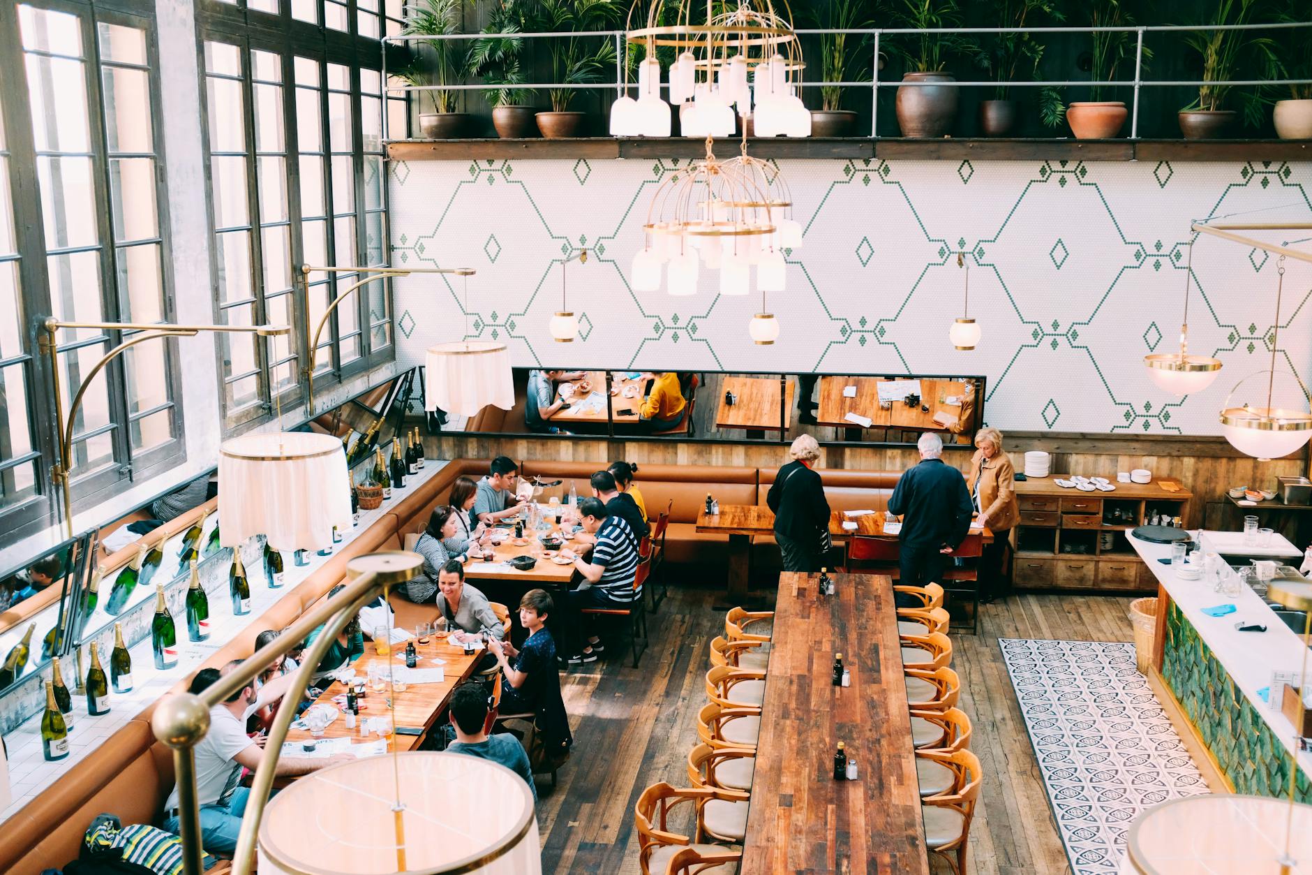 Groups of people dining and socializing in relaxed food hall environment with ambient lighting
