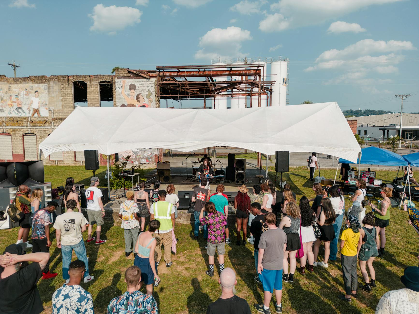 Small group of people gathered around listening to music together
