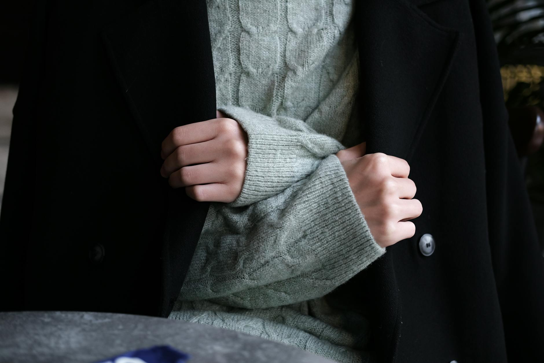 Elegant neutral-colored cashmere sweater representing logo-free luxury fashion trends