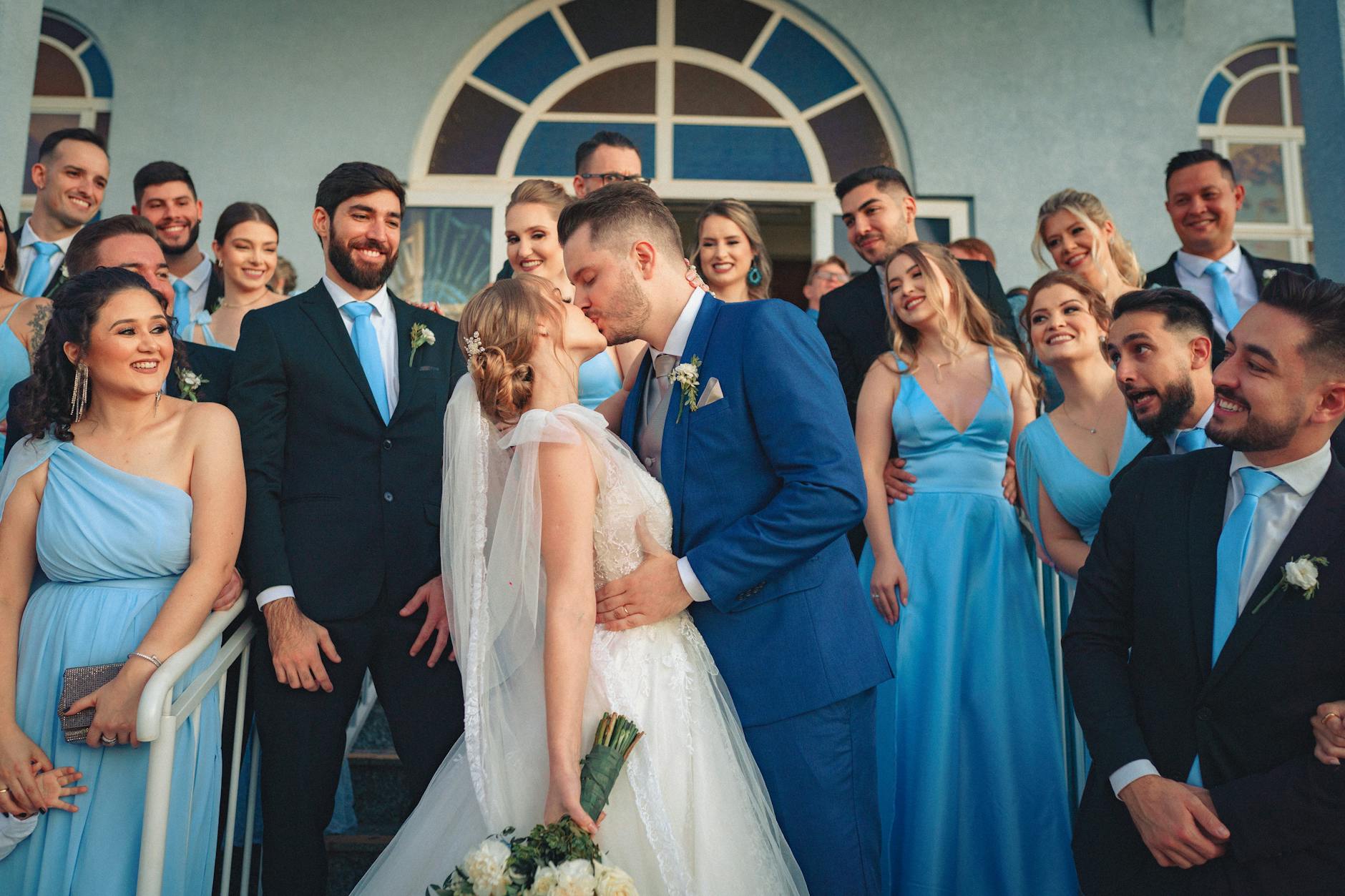 Wedding photographer capturing intimate moments between couple in natural outdoor setting