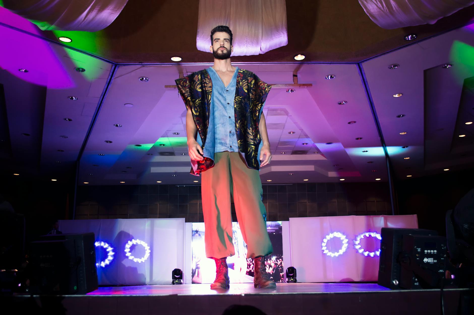 Models on fashion runway wearing vivid colored luxury garments representing dopamine dressing trend