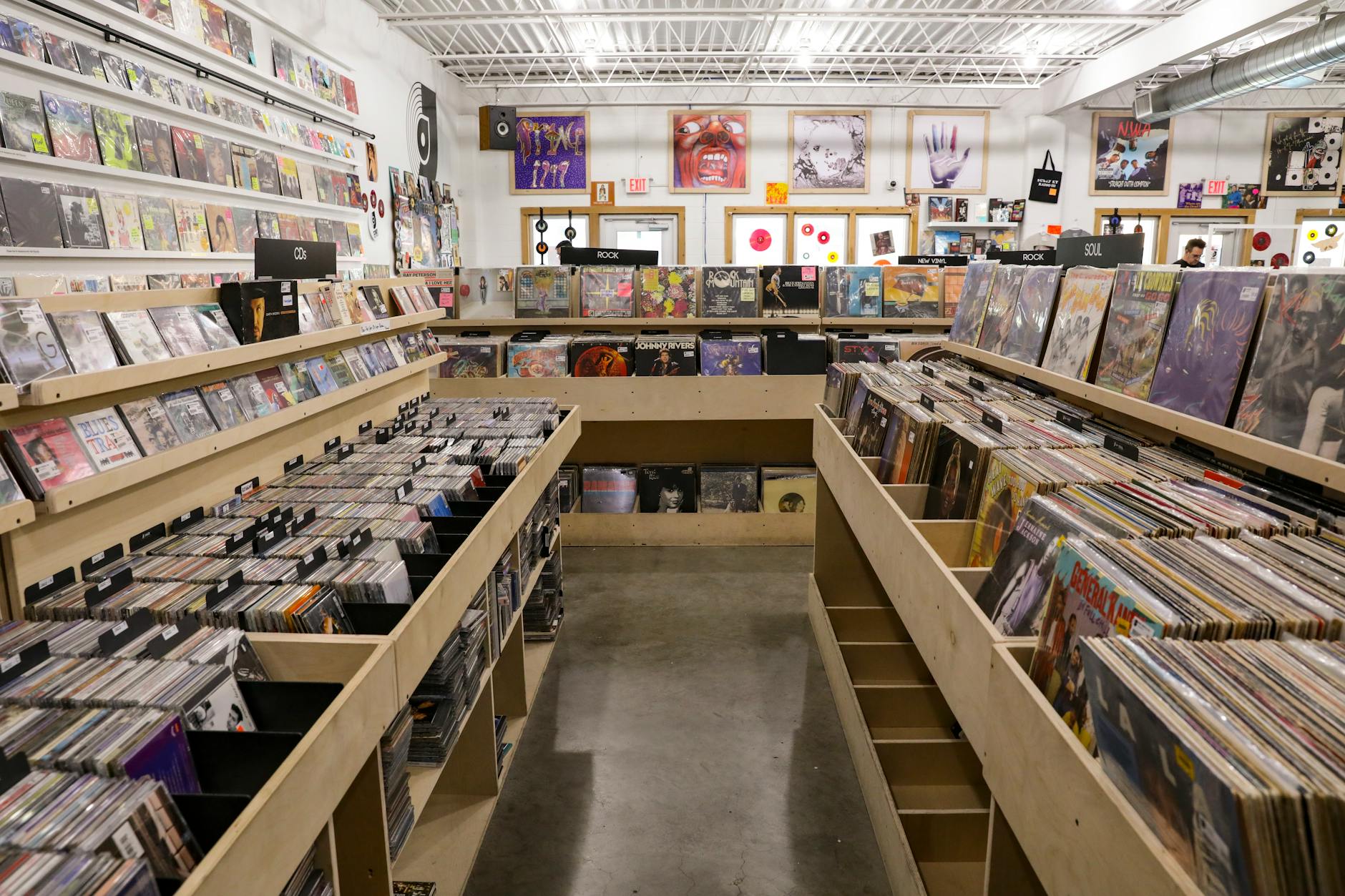 Interior view of an independent record store with vinyl albums displayed on shelves and listening stations