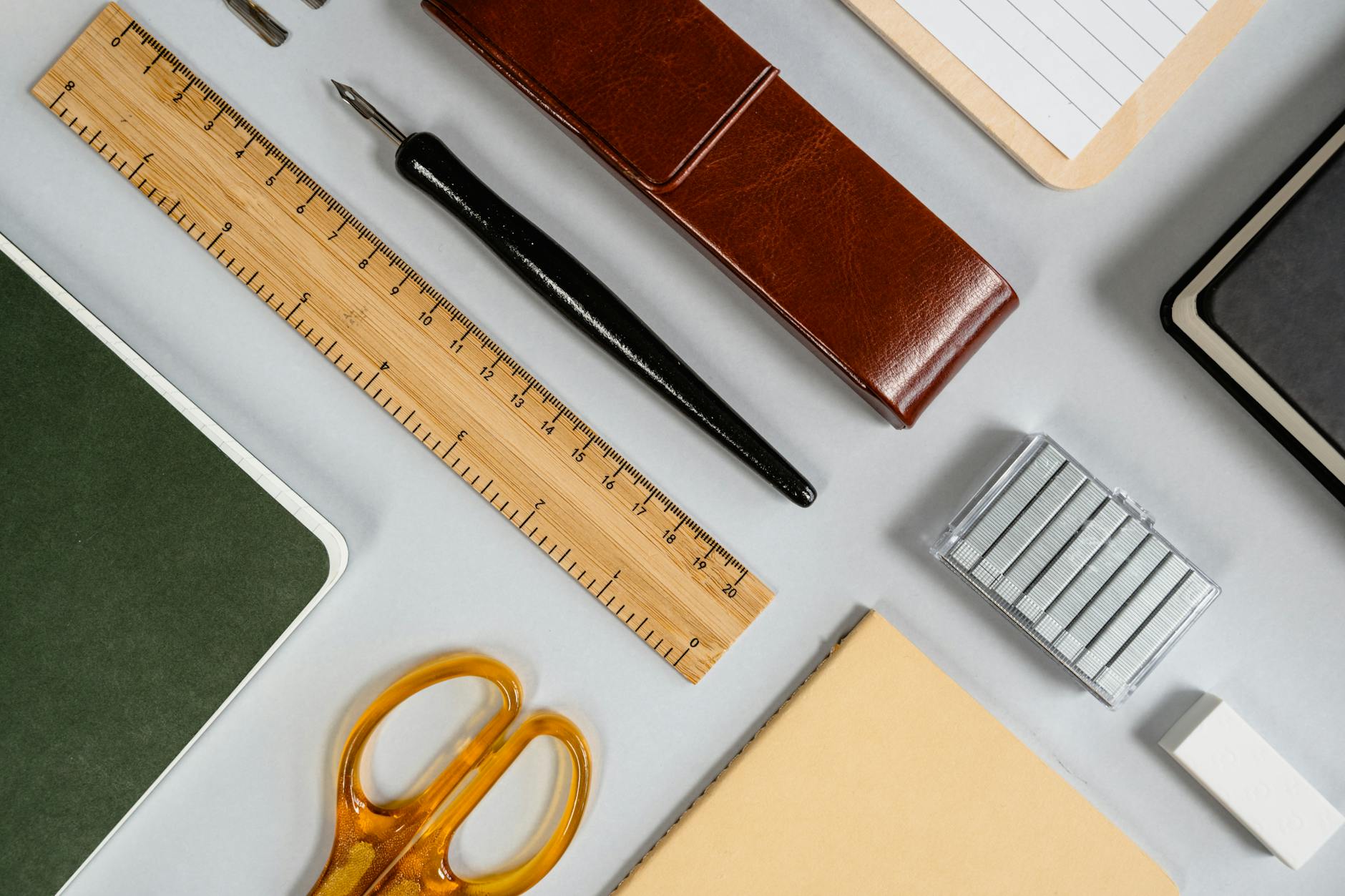 Collection of elegant stationery including paper, envelopes, and writing instruments arranged on desk