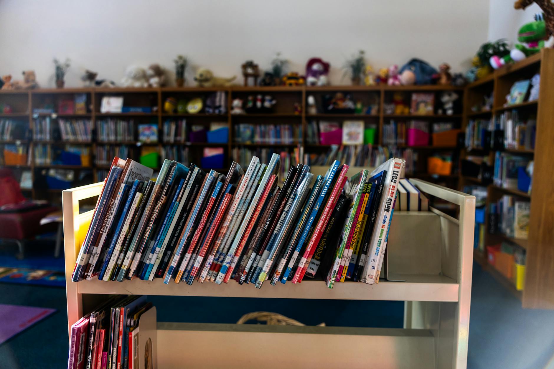 Stack of hardcover books arranged on library table with soft lighting