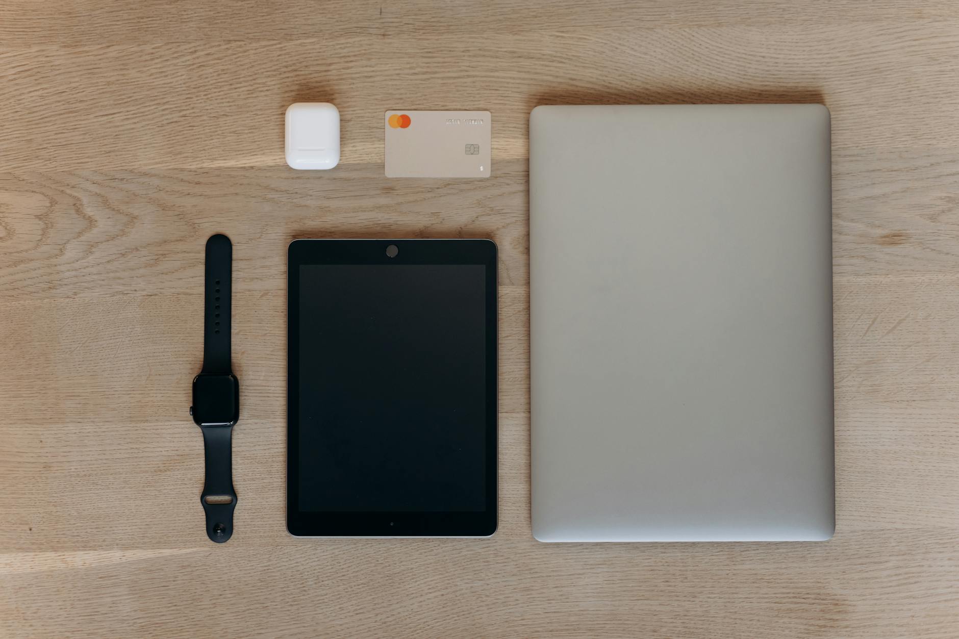 Various technology devices and gadgets arranged on a clean desk surface