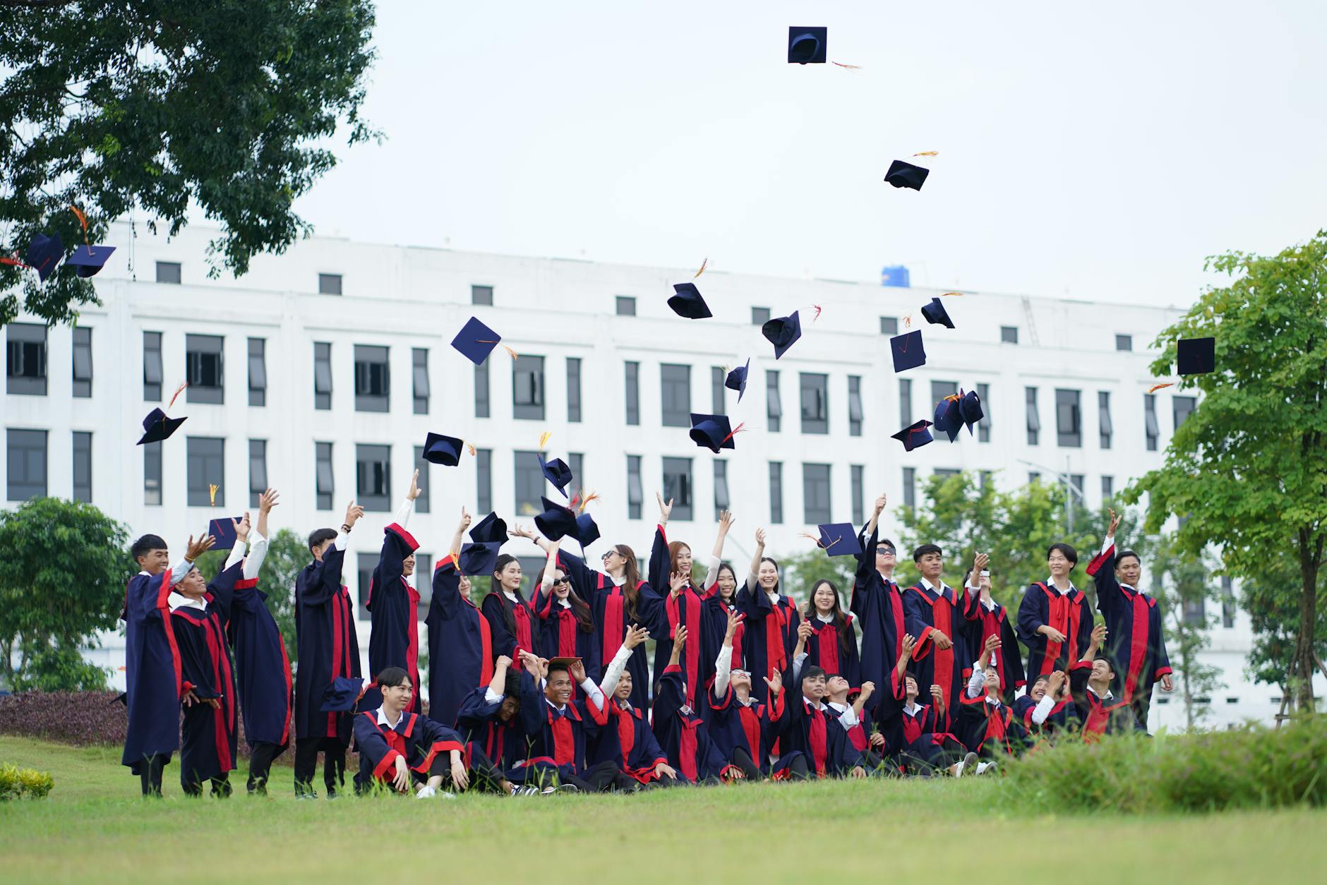 Diverse group of students in graduation caps celebrating their achievement