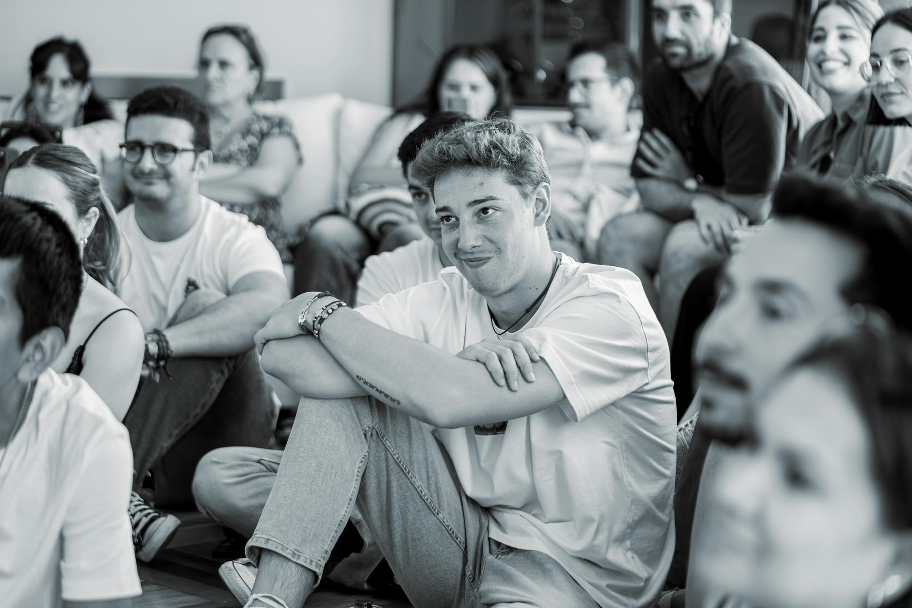 Diverse audience members enjoying a live performance in a welcoming venue atmosphere