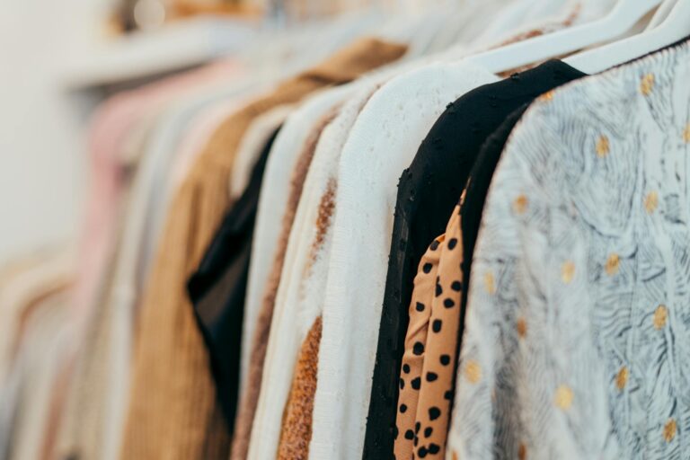 Vintage clothing hanging on rack in boutique store