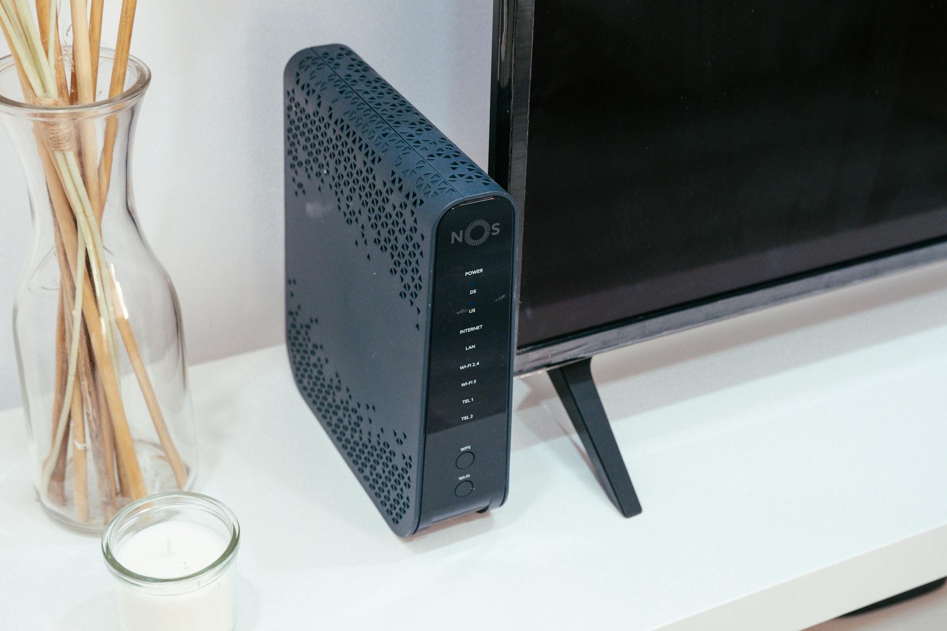 Modern wireless router with LED indicators on desk