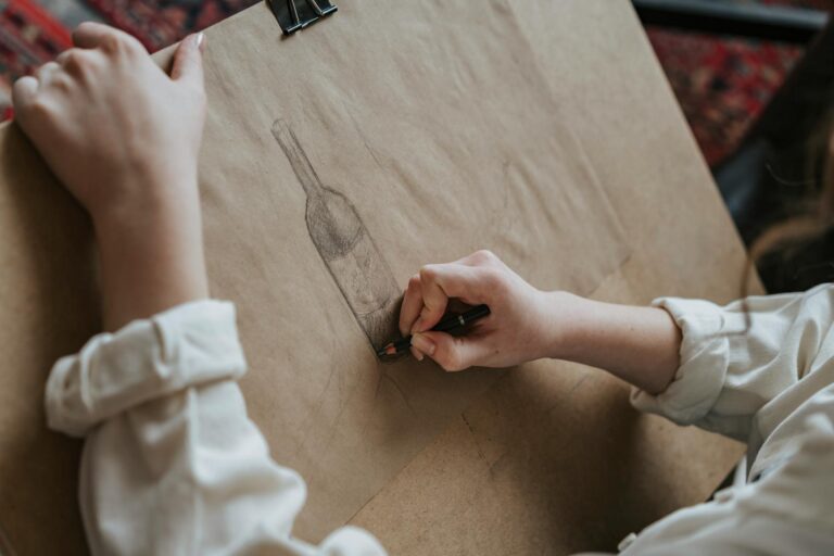Artist's drawing table with sketches and charcoal materials