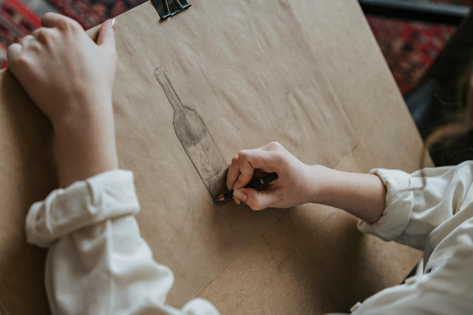 Artist's drawing table with sketches and charcoal materials
