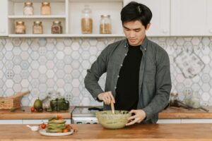 Man learning to cook in modern kitchen