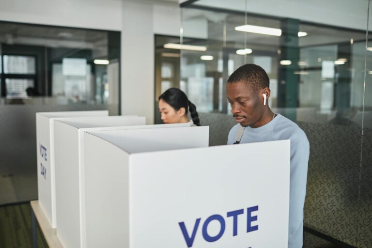 Empty voting booth with American flag backdrop during primary election