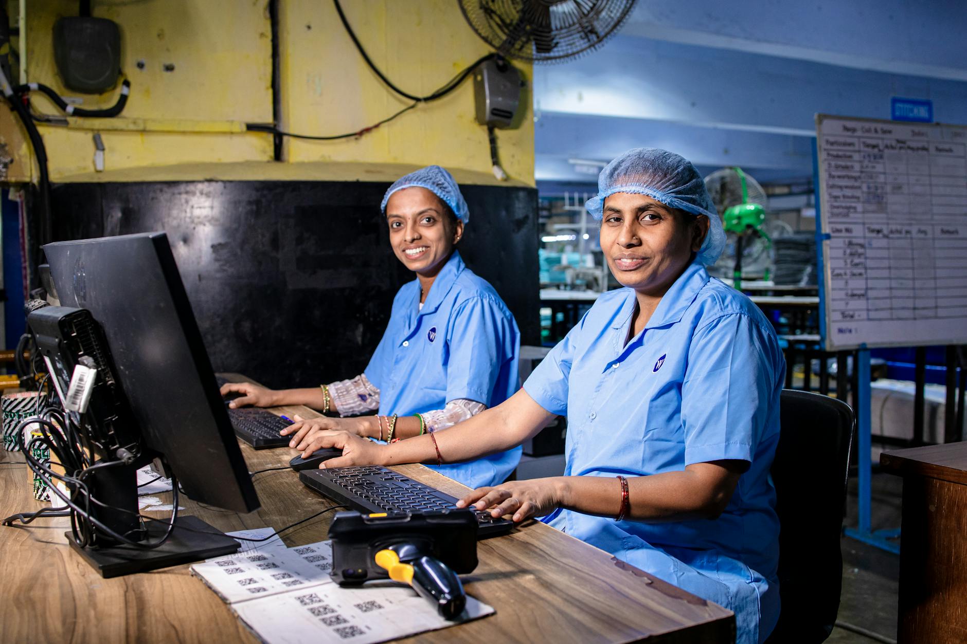 Office workers using computers and digital tools at desks