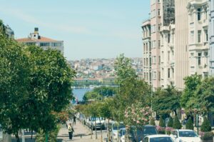 Narrow Istanbul street with historic buildings and pedestrians at dusk