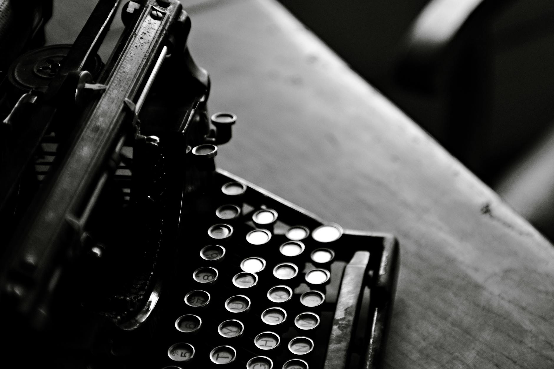 Close-up of vintage typewriter keys and paper, representing literary creation