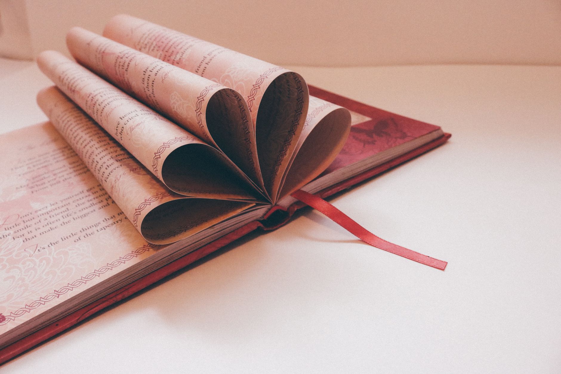 Open poetry collection resting on a table with soft natural light