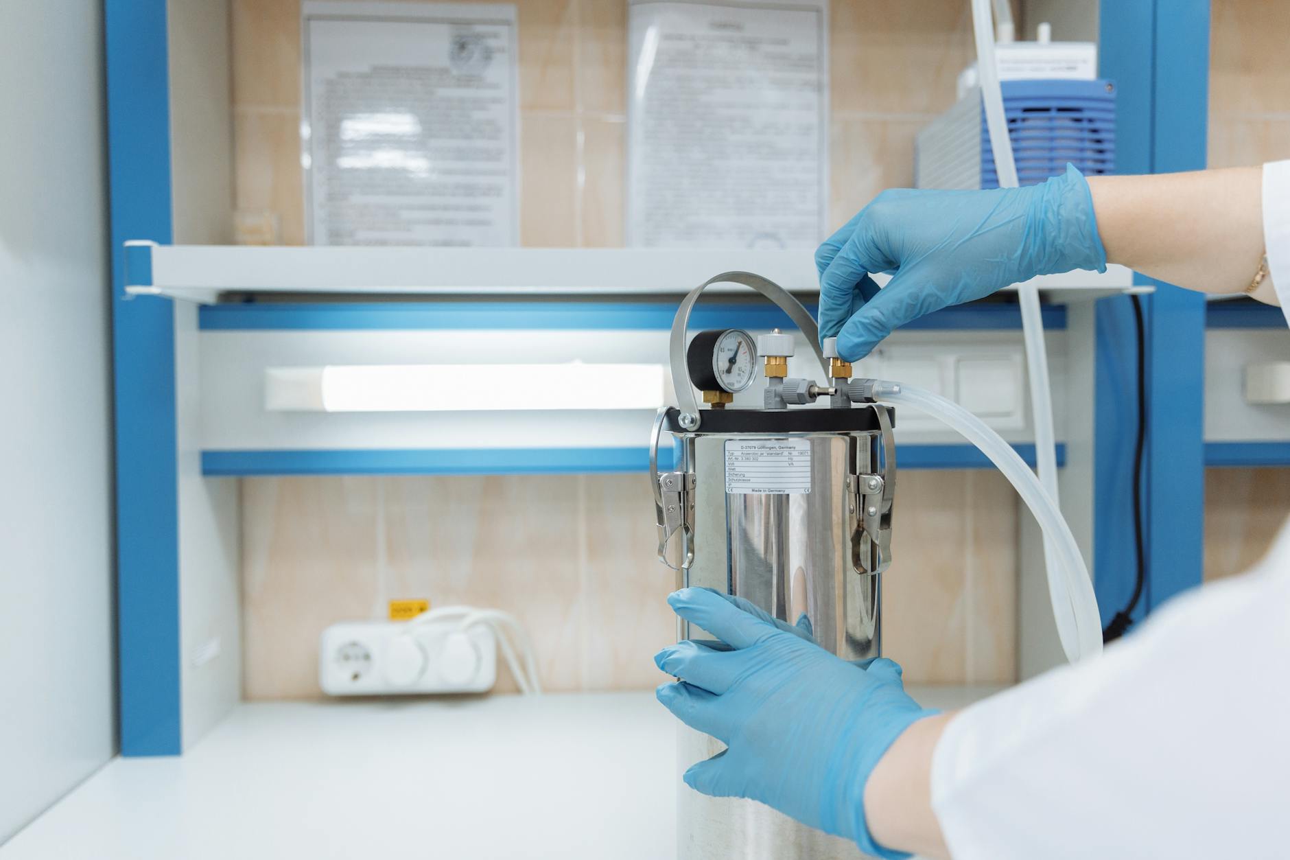Researcher working at a laboratory bench with equipment and samples