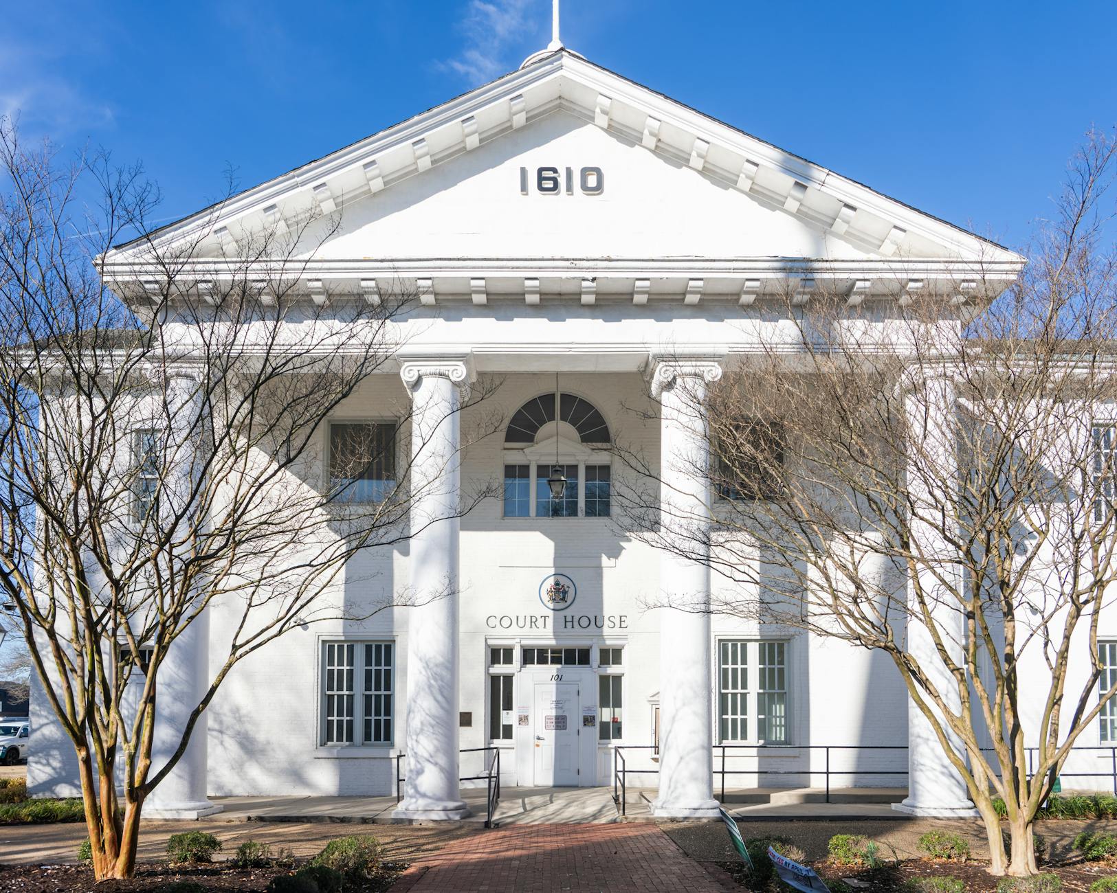 Stone courthouse exterior with classical columns and steps