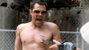A stunt performer mid-action against an outdoor backdrop representing physical risk entertainment