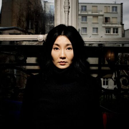 Close-up portrait of an Asian actor in contemplative pose