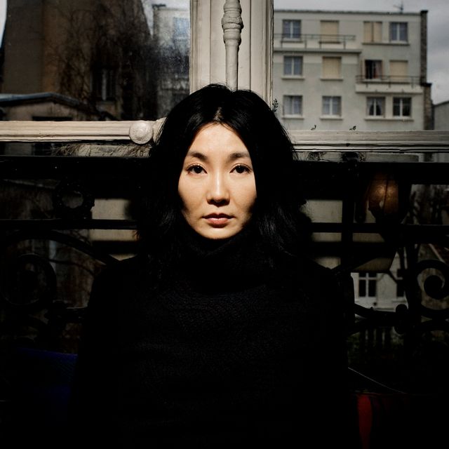Close-up portrait of an Asian actor in contemplative pose