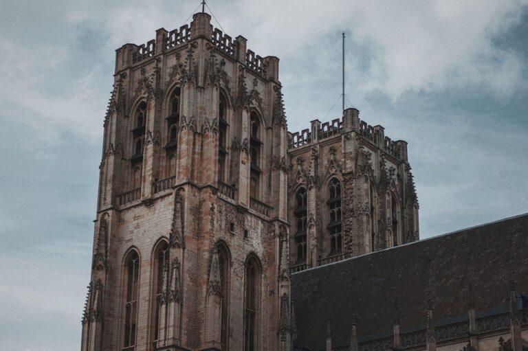 Stone tower of a medieval abbey against an overcast sky