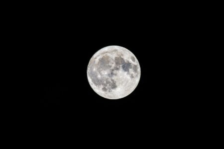 A satellite orbiting Earth against a dark starfield background