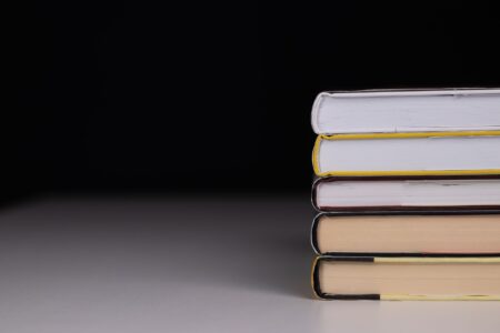 A dark, atmospheric hardcover book on a shadowed surface suggesting horror fiction