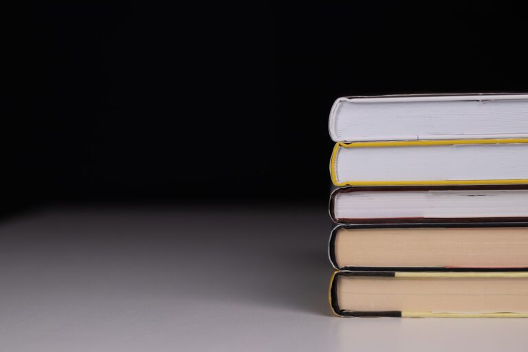 A dark, atmospheric hardcover book on a shadowed surface suggesting horror fiction