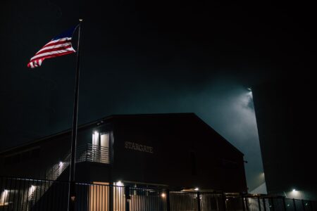 Falcon 9 rocket launching from Cape Canaveral at night with bright engine exhaust