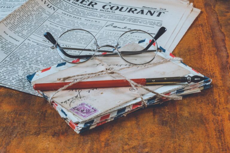 Aged academic journal pages spread open on a wooden desk