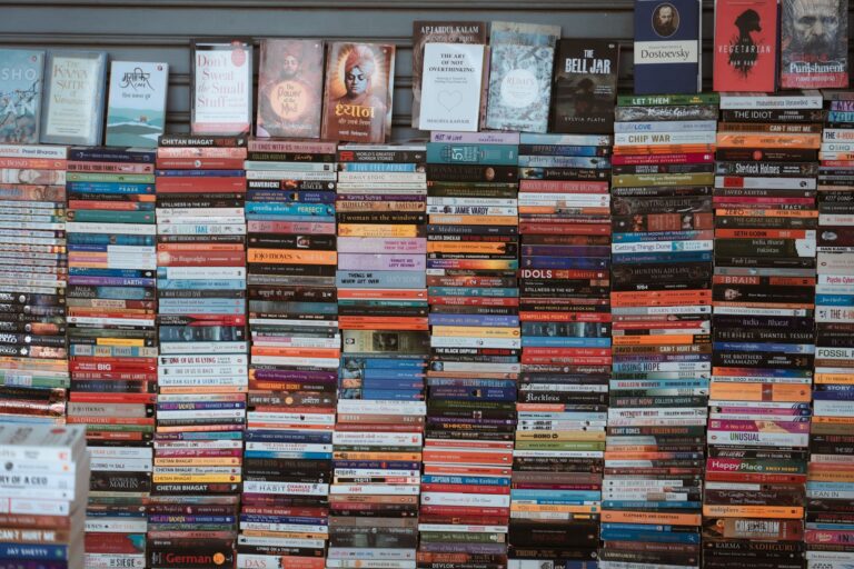Speculative Fiction Imagines a Sapphic and Lesbian Future Stack of science fiction paperbacks on a wooden surface with dramatic lighting