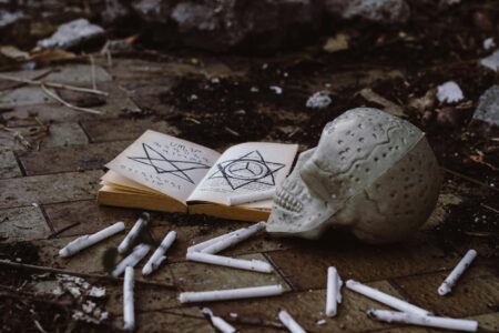Dark atmospheric book open on a table with dim candlelight