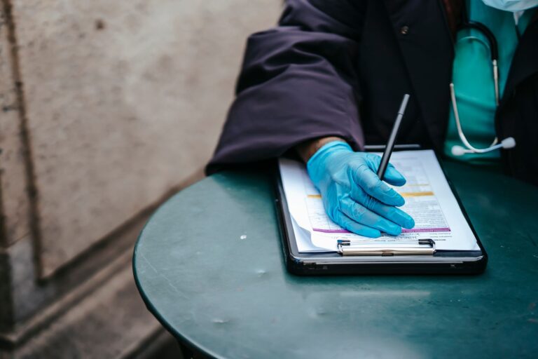 AI Enters the Prior Authorization War, and Doctors Are Alarmed A physician reviewing paperwork at a medical office desk