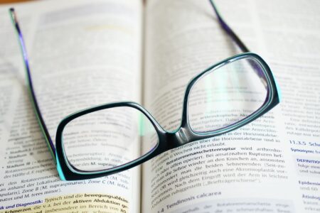 Open novel resting on a table with soft light, suggesting literary reading