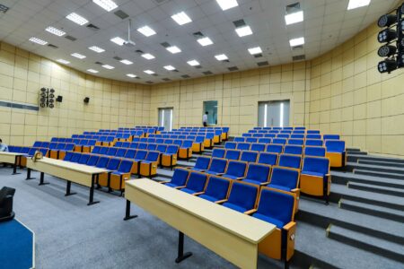 AI Cheating Scandal Rocks Brown University, Sparking Academic Integrity Debate Empty university lecture hall with rows of wooden seats and a front chalkboard