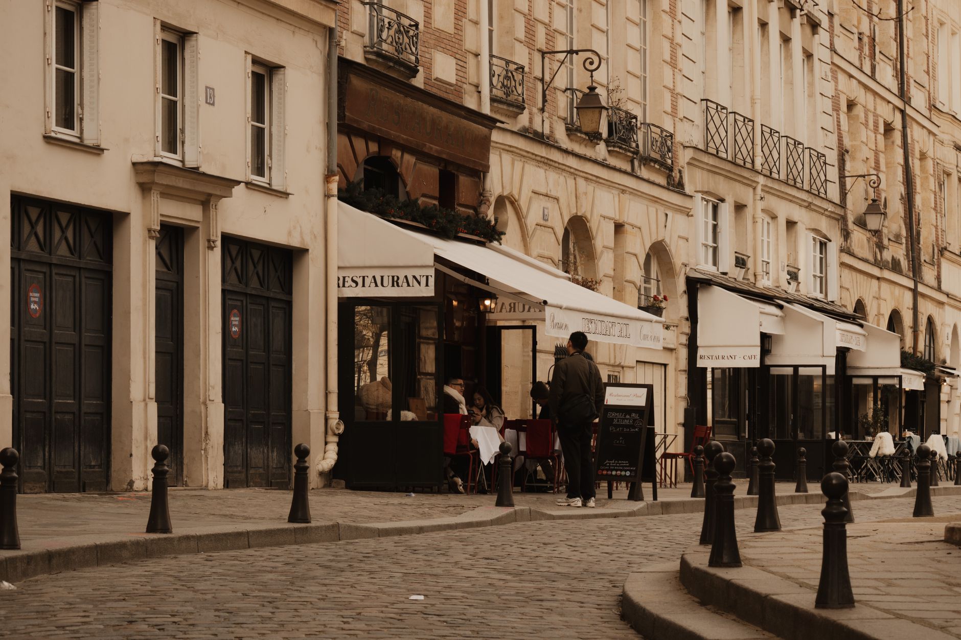 A quiet Paris street cafe, evoking the European city setting of Cusk's novel