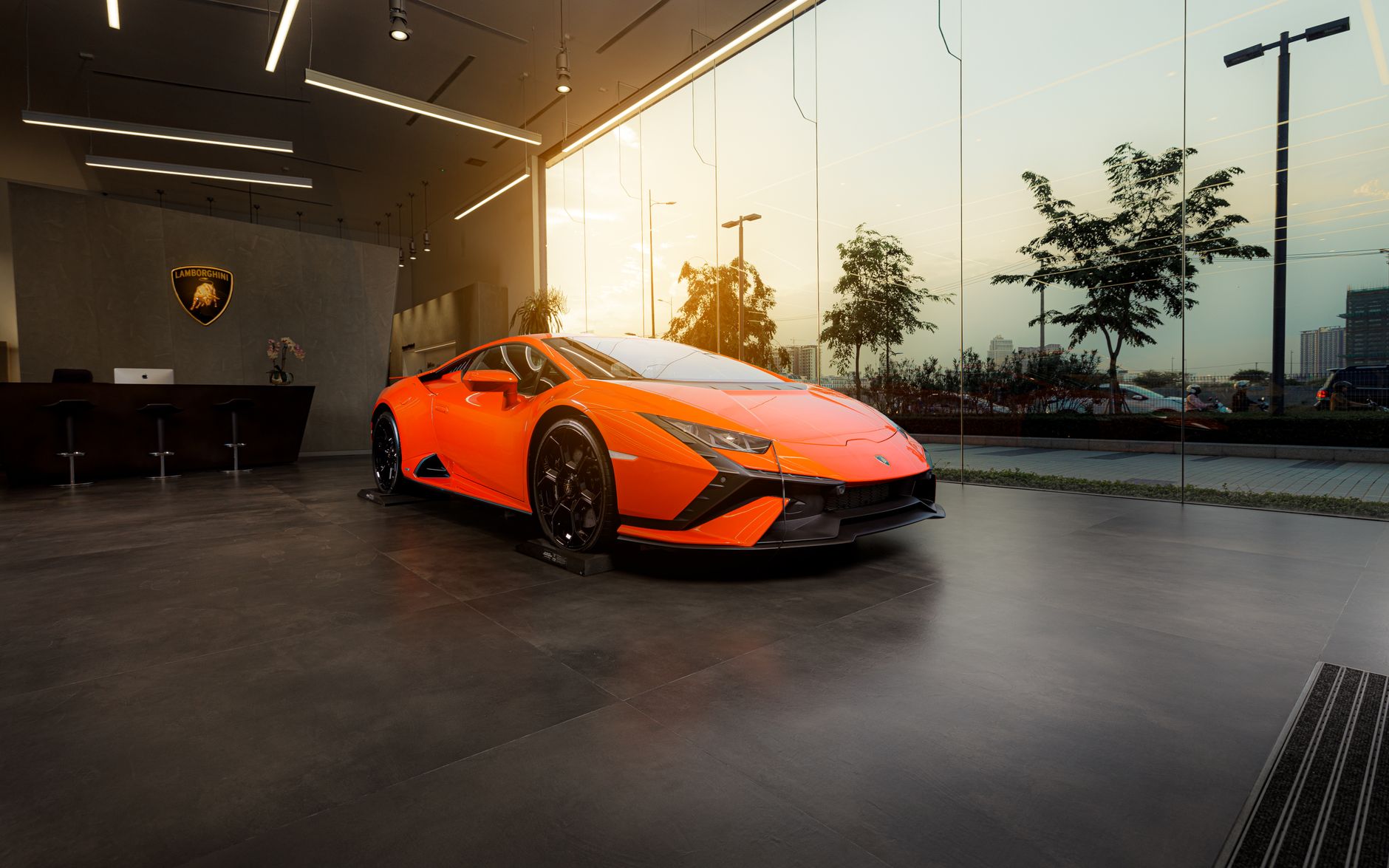 Full-size luxury vehicles displayed inside a contemporary automotive showroom